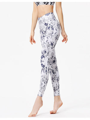 White leggings with a blue cosmic floral print and piping detail.