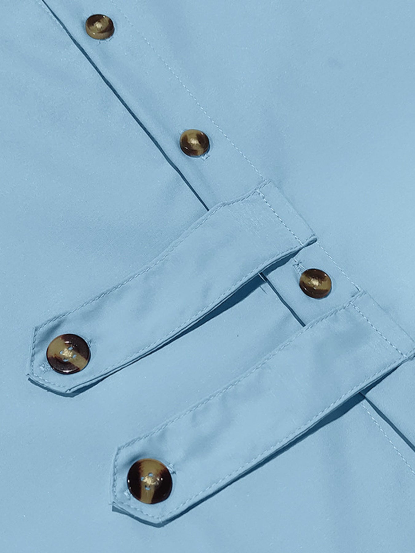 Light blue cotton men's long-sleeve shirt with button details and tortoise shell buttons.