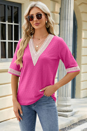 Hot pink textured V-neck top with white lace trim on neckline and sleeves.