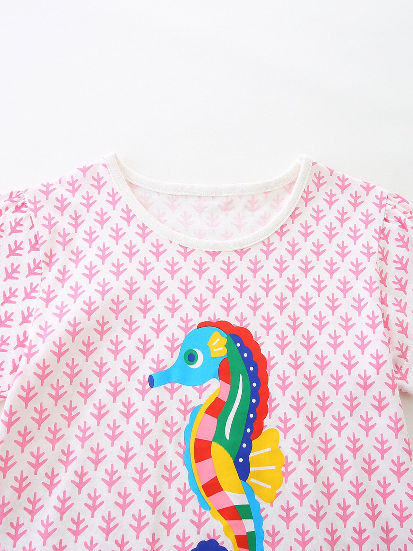Toddler cotton tee with pink leaf pattern and colorful seahorse graphic.