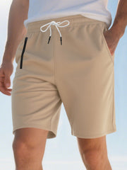 Khaki chino shorts for men with drawstring waist and zip pocket detail.