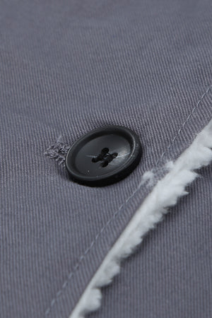 Sherpa-lined canvas button-down jacket in dark gray, showing a black button and fuzzy trim detail.