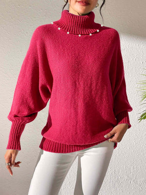 Deep Red knit sweater with pearl-embellished turtleneck and dolman sleeves.