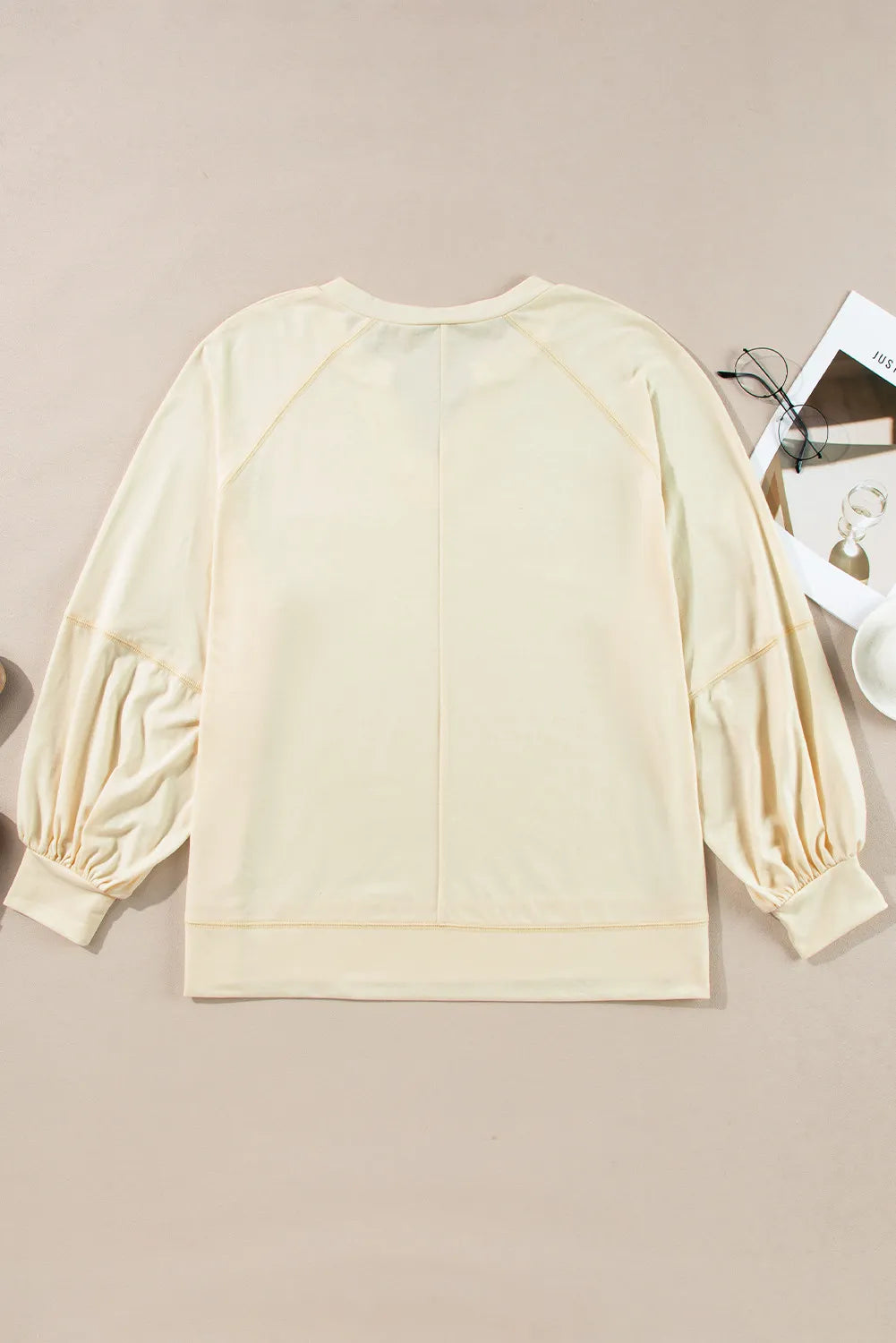 Gathered sleeve pastel yellow blouse with a V-neck and relaxed fit.