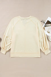 Gathered sleeve pastel yellow blouse with a V-neck and relaxed fit.