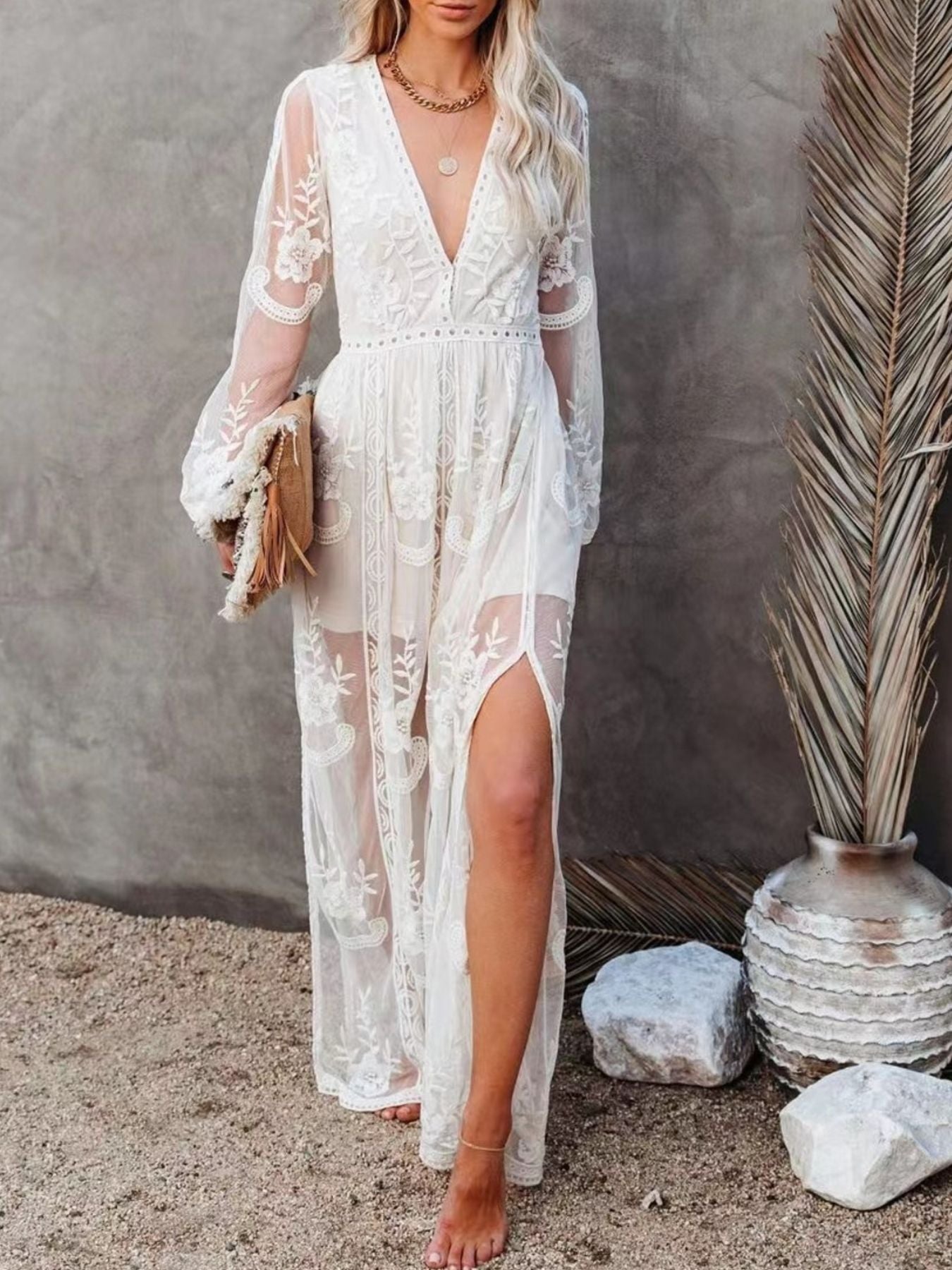 White floral lace maxi dress with V-neck, long sleeves, and a high slit.