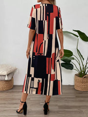 Geometric v-neck midi dress in abstract print with short sleeves and a flowy skirt.