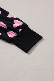 Black pajama set with pink heart print and ribbed cuffs