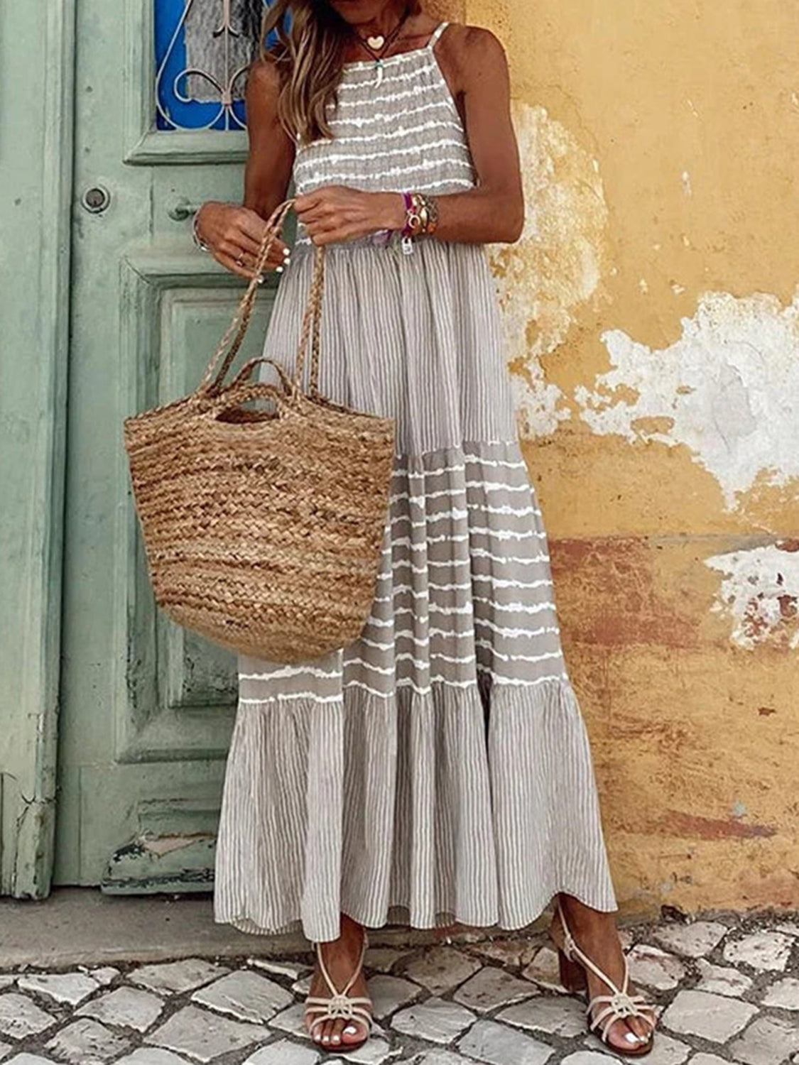 Light gray tiered maxi dress with horizontal stripes, cami straps, and a flowy skirt.