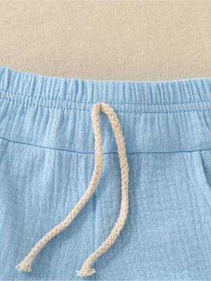 Blue cotton shorts with elastic waistband and drawstring detail