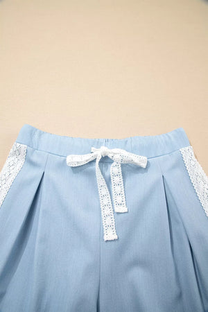 Light blue maternity pants with lace trim and drawstring detail.