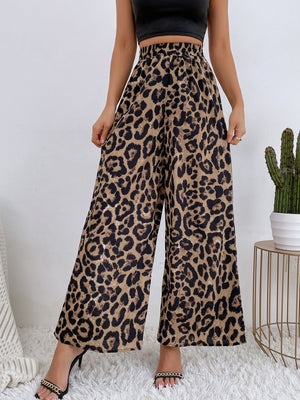 Leopard print palazzo trousers with a high waist and wide leg, styled with a black crop top.