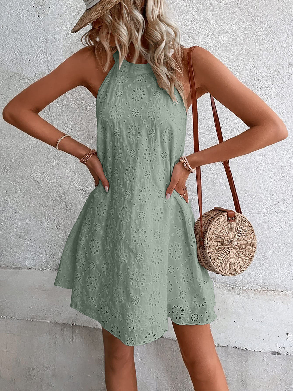 Sage halter neck eyelet trapeze dress with a floral pattern and A-line skirt.