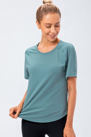 Teal performance raglan crew neck tee with short sleeves.