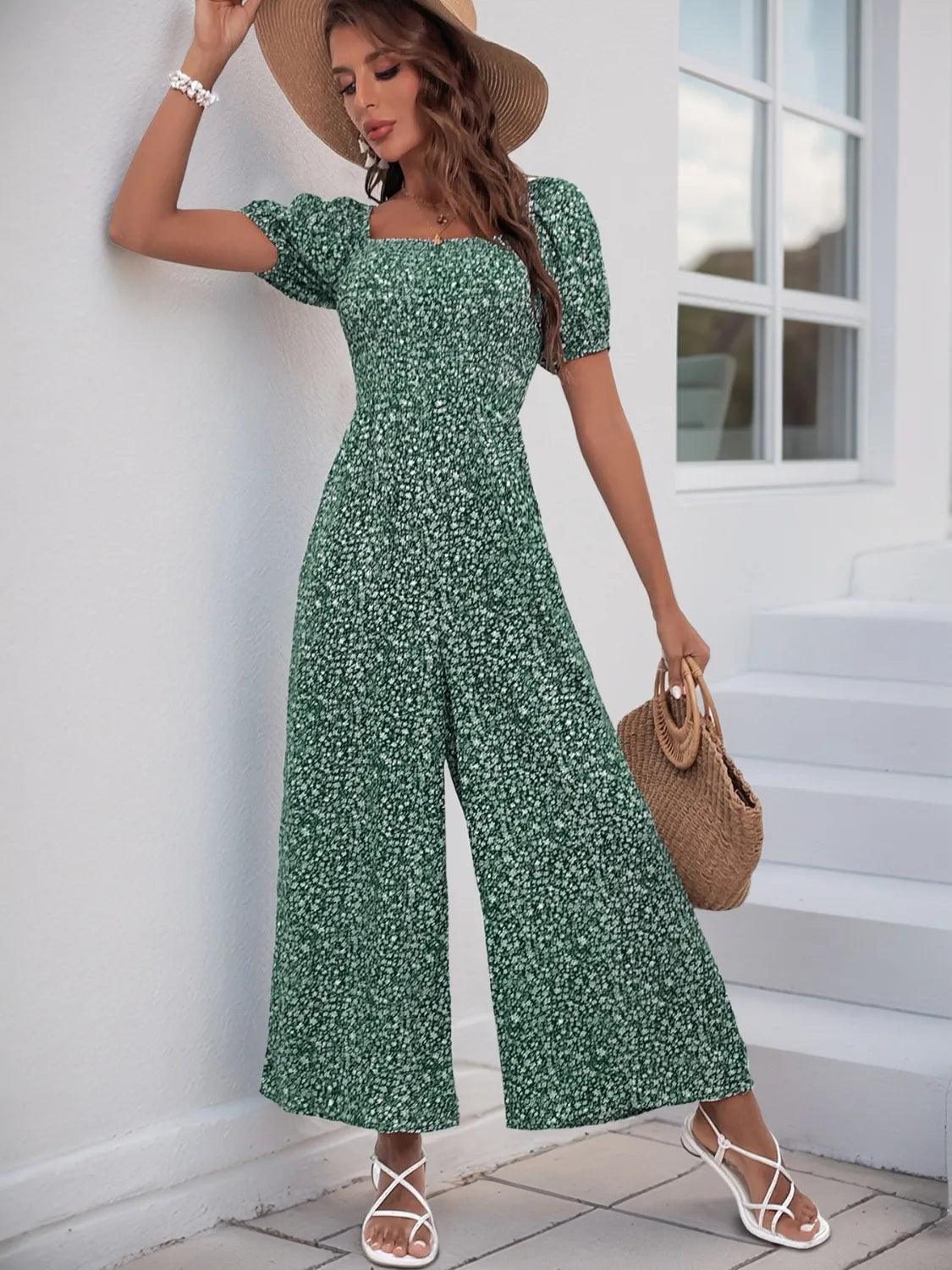 Dark Green floral smocked bodice jumpsuit with puff sleeves and wide legs.