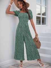 Dark Green floral smocked bodice jumpsuit with puff sleeves and wide legs.
