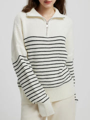 Cream ribbed knit sweater with black horizontal stripes and a half-zip neckline.