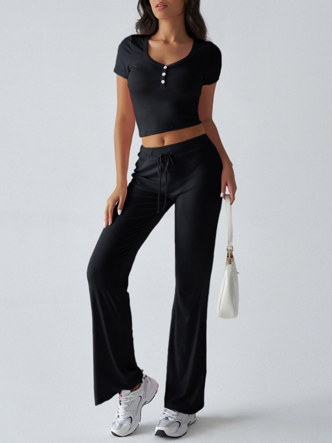 Black button-front crop top and flared lounge pants with drawstring waist.
