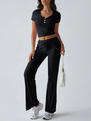 Black button-front crop top and flared lounge pants with drawstring waist.
