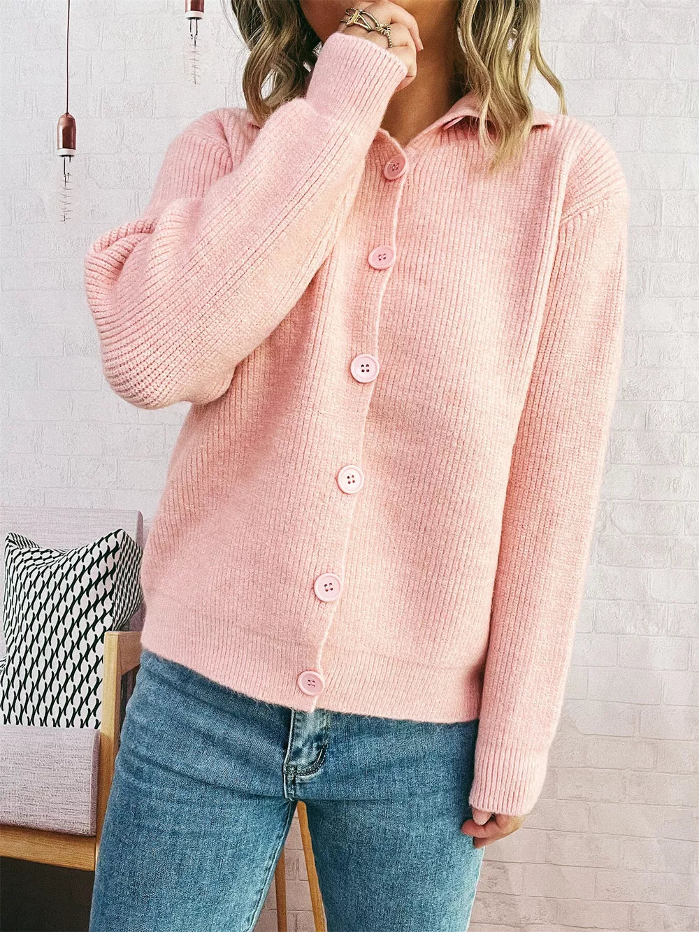 Pink ribbed button-up cardigan with polo collar and matching buttons.