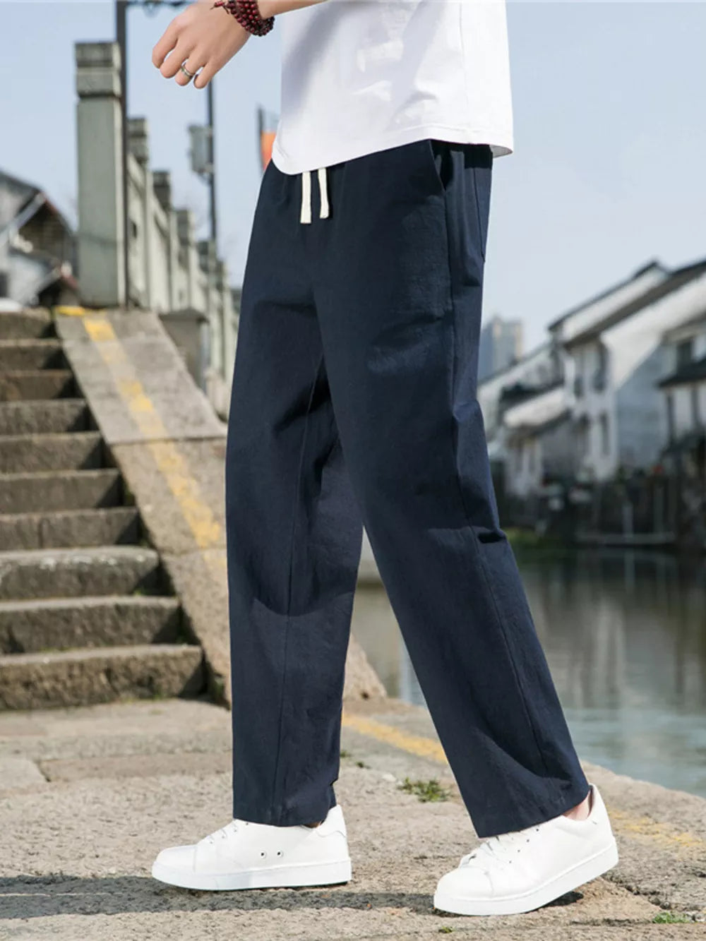 Navy blue men's sweatpants with drawstring waist and straight leg