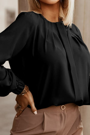 Black pleated yoke blouse with button detail and long sleeves