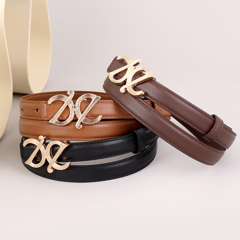 Premium cowhide leather belts in black, brown, and caramel with gold logo buckle.