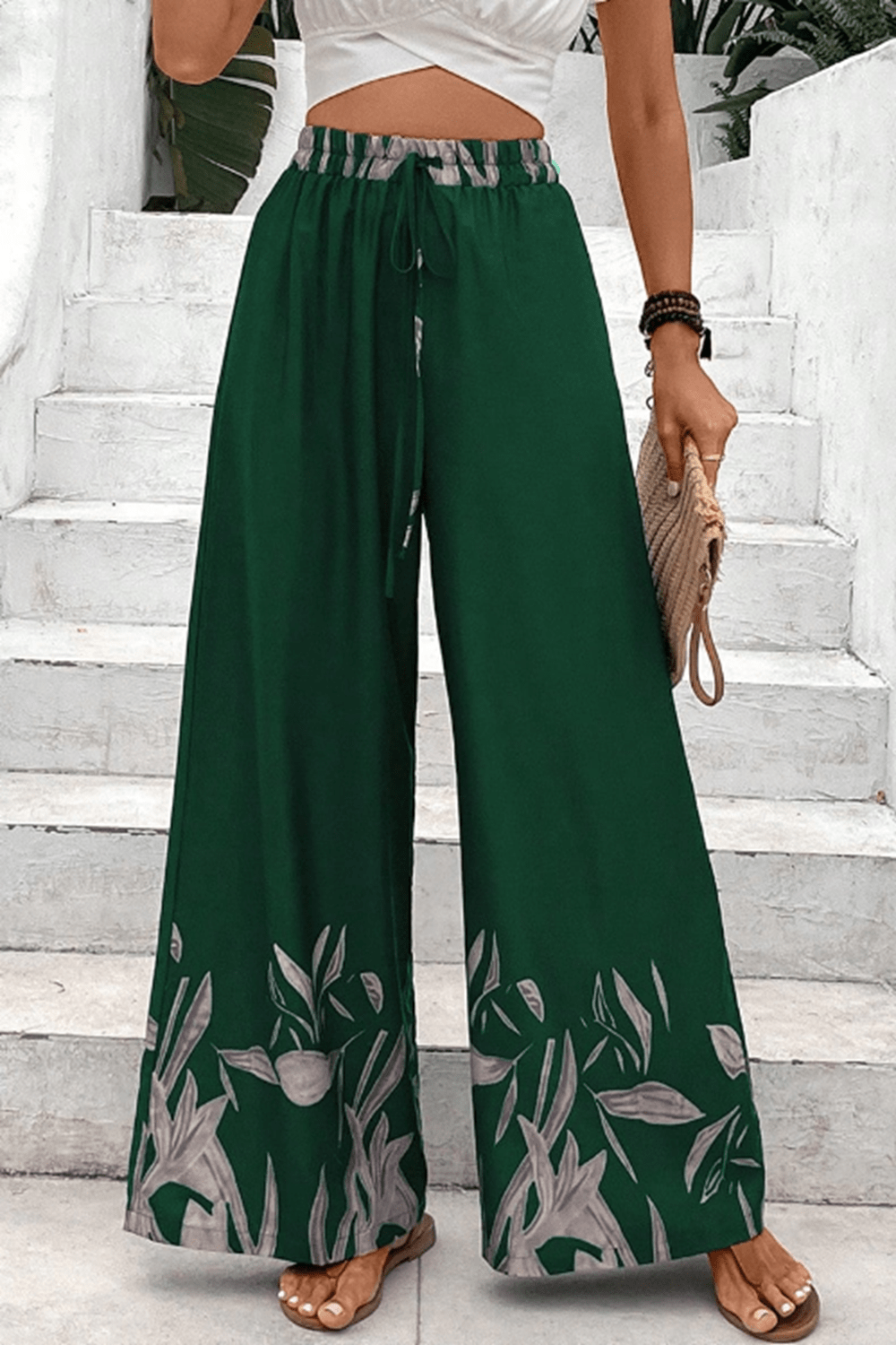 Green wide-leg lounge trousers with botanical print hem and drawstring waist