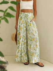 Palazzo trousers with white base and all-over yellow pineapple and green leaf print.