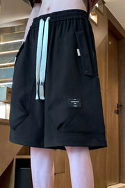 Black relaxed fit chino shorts with drawstring and pocket details.