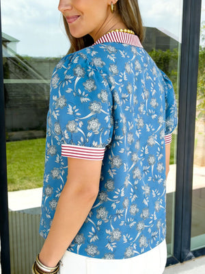 Blue floral cotton blouse with puff sleeves and a striped collar and cuffs.