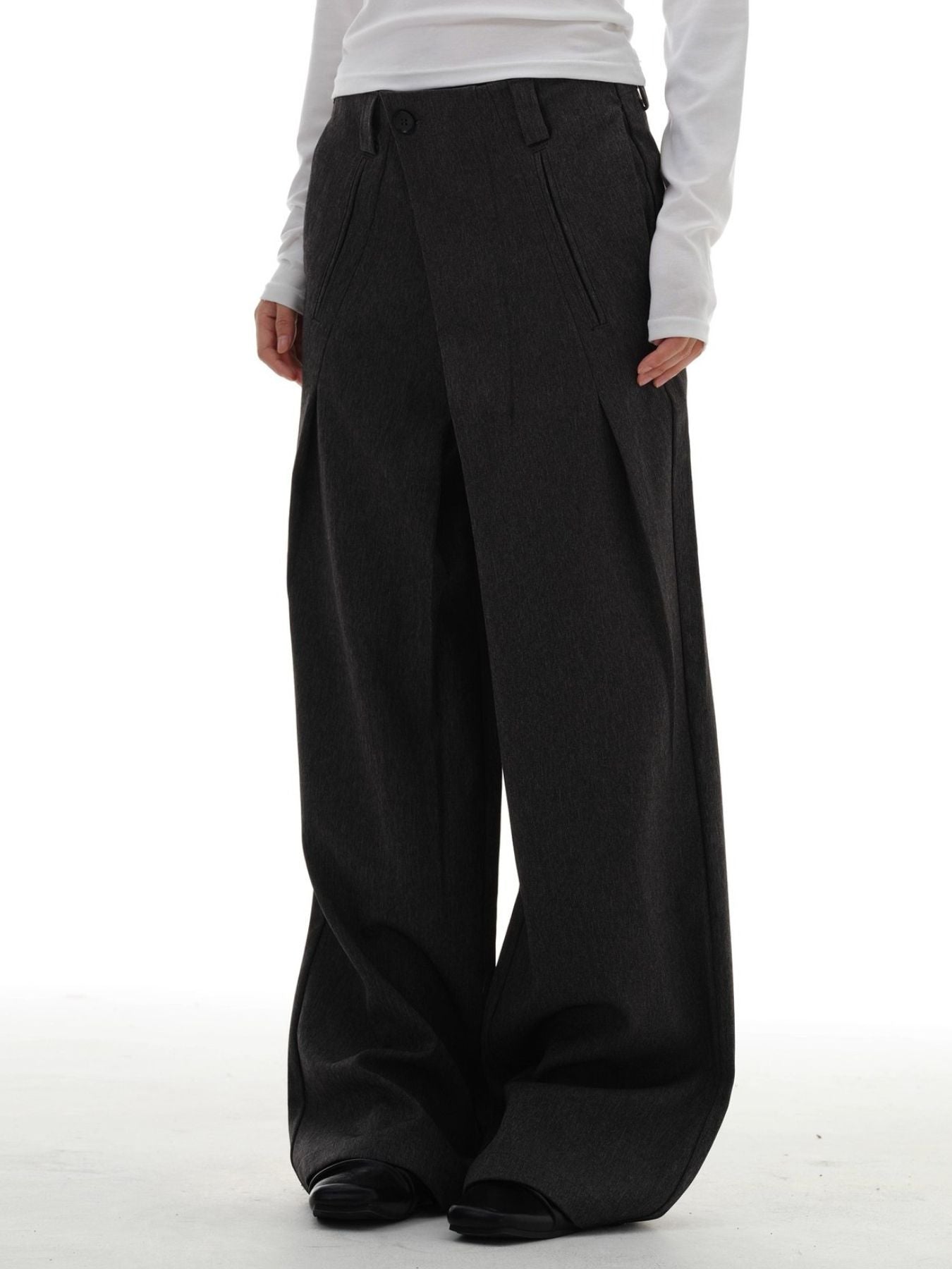 Men's dark grey wide-leg pleated trousers with a relaxed fit.
