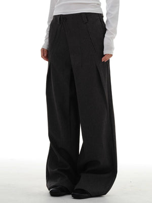 Men's dark grey wide-leg pleated trousers with a relaxed fit.