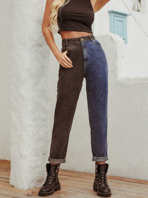 Split-tone straight leg jeans in medium wash denim with a dark contrast leg, cuffed hem.