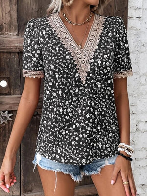Black floral V-neck blouse with lace trim and short sleeves
