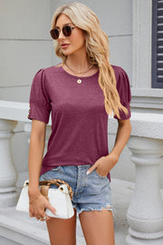 Gathered sleeve tee in Red-Violet with gold button detail on sleeves.