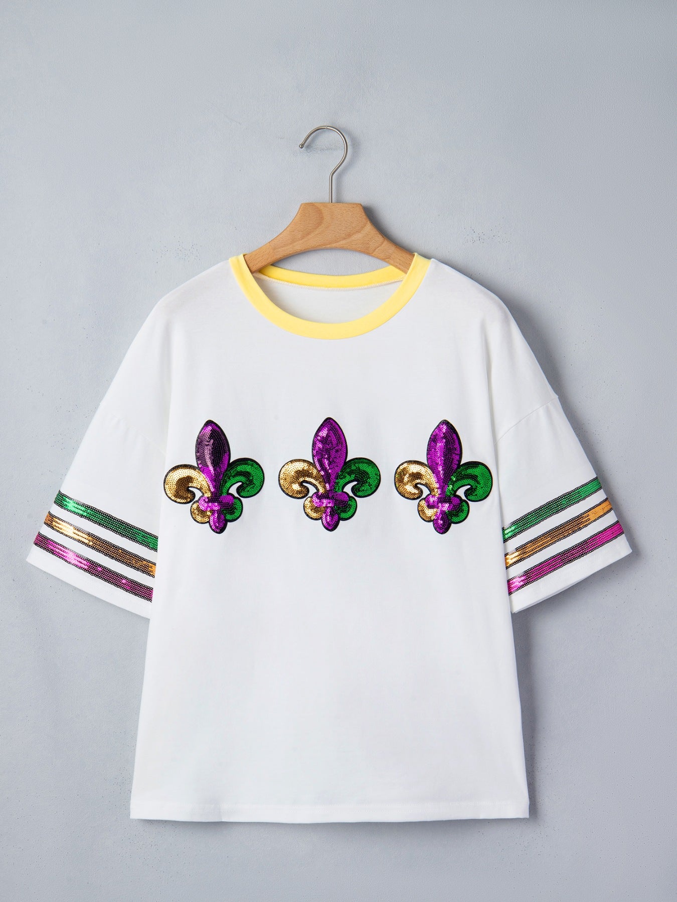 White maternity t-shirt with sequin fleur-de-lis and striped sleeves.