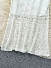 White openwork maxi skirt with intricate knit patterns and a flowing hem.