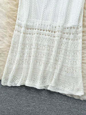 White openwork maxi skirt with intricate knit patterns and a flowing hem.
