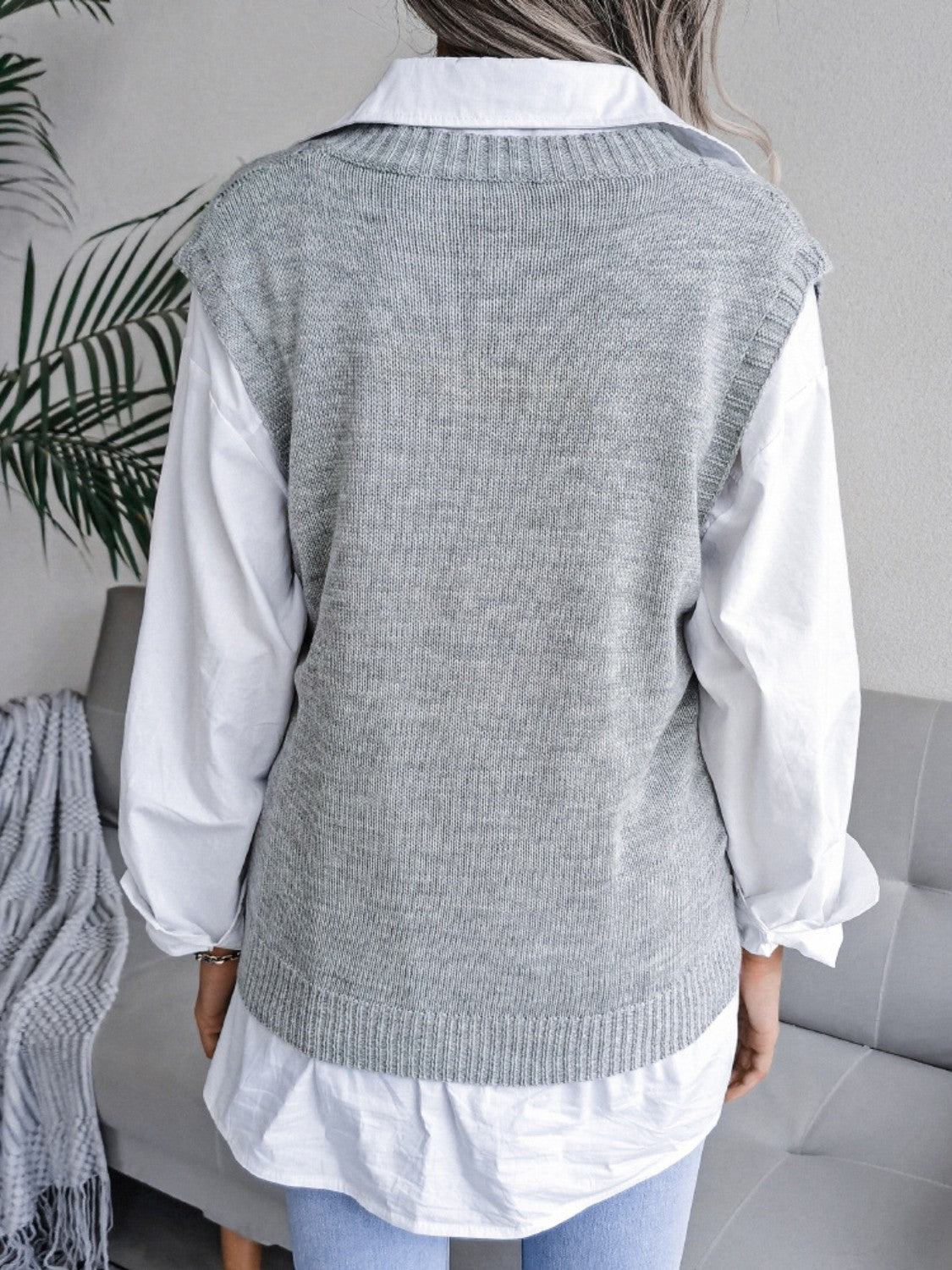 Light gray acrylic openwork cable knit vest over a white collared shirt.