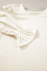 Textured ruffle sleeve blouse in eggshell with ribbed fabric and a scoop neckline.