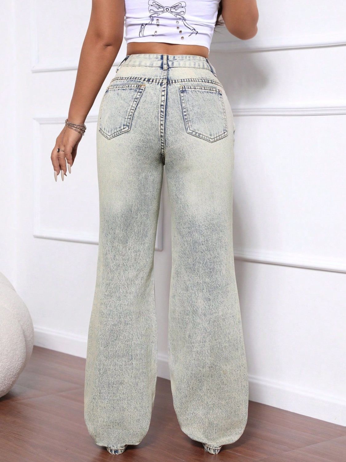 Light acid wash distressed wide-leg jeans in denim with a high waist.