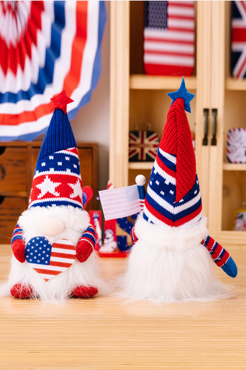 Patriotic knit gnomes in red and blue, one holding a heart, the other a flag.
