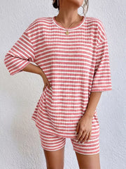 Pink striped two-piece set with elbow sleeves and shorts.