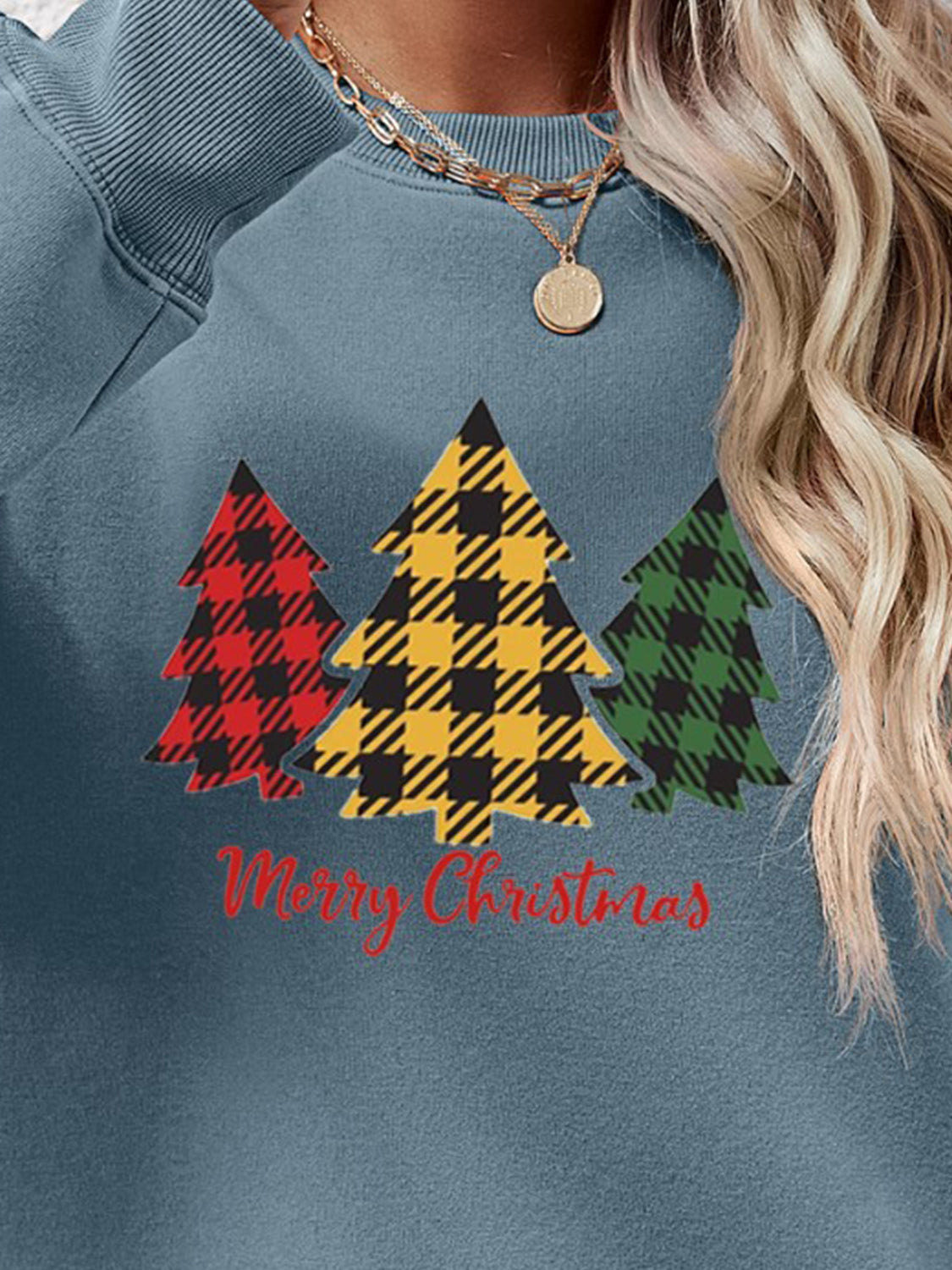 Crewneck sweatshirt in Misty Blue with plaid Christmas trees graphic and Merry Christmas text.