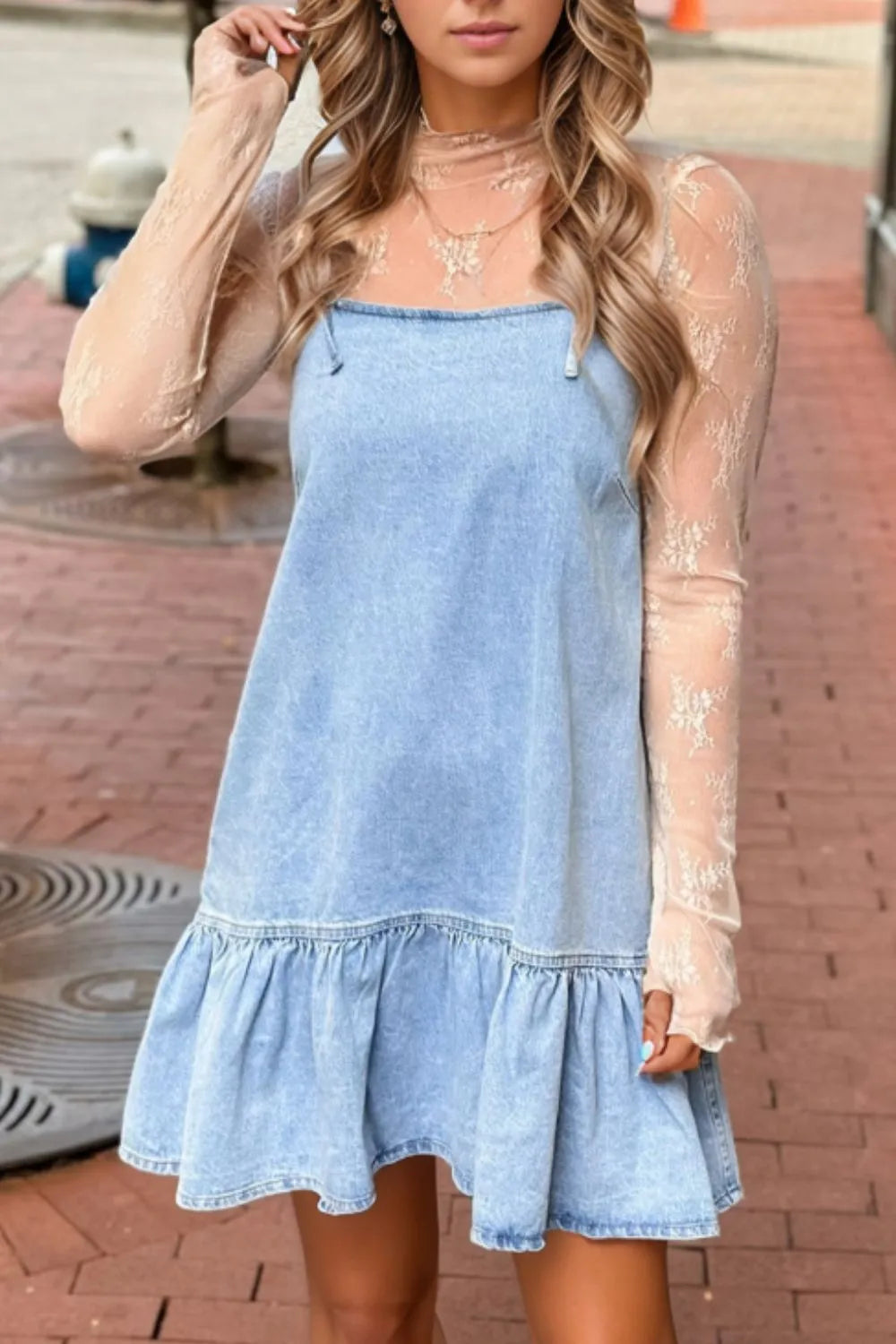 Light blue denim sundress with ruffled hem and spaghetti straps, styled with a sheer lace top.