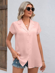 Blush pink textured collared shirt with short sleeves and button front.
