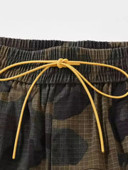 Utility camo cargo shorts with elastic waistband and yellow drawstring detail.