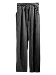 Textured wide-leg drawstring lounge trousers in dark gray with pockets.