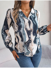 Women's abstract swirl print silk blouse with button front and long sleeves.